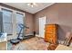 Bedroom with a treadmill, dresser, and natural light from the two large windows at 524 N Meridian St, Lebanon, IN 46052