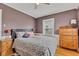 A comforting bedroom featuring hardwood floors, neutral walls, natural light, and a comfortable bed at 524 N Meridian St, Lebanon, IN 46052