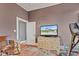 Cozy bedroom featuring neutral walls, a colorful rug, a television, and natural light at 524 N Meridian St, Lebanon, IN 46052