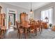 Cozy dining room with wood table, upholstered chairs, vintage cabinets, and natural light from the windows at 524 N Meridian St, Lebanon, IN 46052