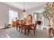 Traditional dining room with wood table, chairs, and a view into the living room at 524 N Meridian St, Lebanon, IN 46052