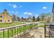 Charming view from front porch with wrought iron railing showing street and sidewalk with well maintained houses and lawns at 524 N Meridian St, Lebanon, IN 46052