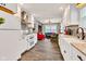 Bright open-concept kitchen with white cabinets, stainless steel appliances, and a view into the living room at 524 N Meridian St, Lebanon, IN 46052