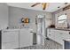 Modern laundry room featuring stylish tile floors, stainless steel appliances, and ample cabinet space at 524 N Meridian St, Lebanon, IN 46052