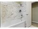 White tub with marble tiled shower and glass shower products at 5344 Tincher Rd, Indianapolis, IN 46221