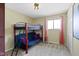 Functional bedroom with a bunk bed, neutral walls and natural light from the window at 5344 Tincher Rd, Indianapolis, IN 46221