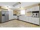 Bright kitchen featuring stainless steel appliances, white cabinets, and wood-look flooring at 5344 Tincher Rd, Indianapolis, IN 46221