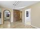 Open layout with brick accent wall, hardwood-style flooring, and neutral paint at 5344 Tincher Rd, Indianapolis, IN 46221