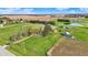 Picturesque aerial of property with mature trees, multiple outbuildings, and serene green fields offering privacy and charm at 5442 W 400 N, Fairland, IN 46126