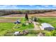 Aerial view showcasing a property with several outbuildings, mature trees, and open green space perfect for country living at 5442 W 400 N, Fairland, IN 46126