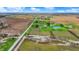 Aerial view of property featuring farmland, houses, ponds, and surrounding landscape at 5442 W 400 N, Fairland, IN 46126