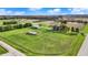 Aerial shot displays expansive green fields, outbuildings, and road access of this charming country property at 5442 W 400 N, Fairland, IN 46126