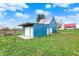 Exterior of a blue barn on a well maintained lawn under a bright blue sky at 5442 W 400 N, Fairland, IN 46126
