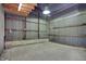 Image of an interior barn space featuring metal walls, concrete flooring, and ample overhead lighting at 5442 W 400 N, Fairland, IN 46126