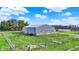 Large metal barn surrounded by green grass and a wooden fence, perfect for agricultural storage at 5442 W 400 N, Fairland, IN 46126
