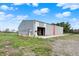 Exterior of a grey barn with an open garage door on a well maintained lawn at 5442 W 400 N, Fairland, IN 46126