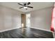 Bedroom with dark flooring, a ceiling fan, neutral walls, and decorative door for a rustic, inviting feel at 5442 W 400 N, Fairland, IN 46126