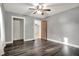 A neutral-toned bedroom features an adjacent walk-in closet and unique wooden door at 5442 W 400 N, Fairland, IN 46126