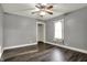 A bright bedroom features hard wood floors, a ceiling fan, and large window for natural light at 5442 W 400 N, Fairland, IN 46126