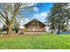 Charming home showcasing a lovely covered porch with wood detail, surrounded by a lush green lawn at 5442 W 400 N, Fairland, IN 46126