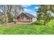 Charming home with a covered porch, green lawn, and mature trees surrounding the property at 5442 W 400 N, Fairland, IN 46126