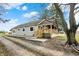 Cozy home featuring a quaint covered porch, complemented by a well-maintained lawn and mature trees at 5442 W 400 N, Fairland, IN 46126