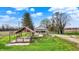 Charming home with a covered patio and well-maintained lawn and a separate red roof structure at 5442 W 400 N, Fairland, IN 46126