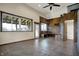An expansive living room boasts a high ceiling, concrete floors, unique wooden accents, and large windows at 5442 W 400 N, Fairland, IN 46126