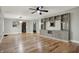 Open living area with beautiful wood floors, built-in shelving, a ceiling fan, and neutral wall paint at 5442 W 400 N, Fairland, IN 46126