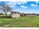 Outbuildings on a well maintained lawn under a bright blue sky at 5442 W 400 N, Fairland, IN 46126