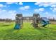 Outdoor playset featuring swings, slides, and climbing structures on a large lawn at 5442 W 400 N, Fairland, IN 46126
