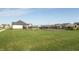 A view of the backyard with a black fence surrounding a community pool at 5694 Walkabout Way, Brownsburg, IN 46112