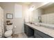 Well-lit bathroom featuring vanity with granite countertop and a toilet at 5694 Walkabout Way, Brownsburg, IN 46112