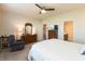 Comfortable bedroom featuring a ceiling fan, dresser, and access to en suite bathroom at 5694 Walkabout Way, Brownsburg, IN 46112