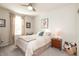Comfortable bedroom with a window, ceiling fan, and decorative accents at 5694 Walkabout Way, Brownsburg, IN 46112
