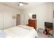 Neutral bedroom with a ceiling fan, soft lighting, and a wooden dresser at 5694 Walkabout Way, Brownsburg, IN 46112