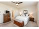 Comfortable bedroom featuring a ceiling fan, dresser, and a large window for natural light at 5694 Walkabout Way, Brownsburg, IN 46112