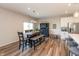 Dining room boasts wood flooring, dining table with bench, and modern lighting at 5694 Walkabout Way, Brownsburg, IN 46112