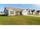 Inviting single-Gathering home with gray siding, lush green lawn, and a neighborhood setting showcasing multiple homes at 5694 Walkabout Way, Brownsburg, IN 46112