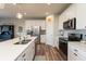 Beautiful kitchen featuring stainless steel appliances, island with sink, and wood-look flooring at 5694 Walkabout Way, Brownsburg, IN 46112
