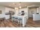 Bright kitchen features white cabinets, stainless steel appliances, and center island with seating at 5694 Walkabout Way, Brownsburg, IN 46112