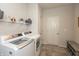 Functional laundry room with modern appliances and storage shelves at 5694 Walkabout Way, Brownsburg, IN 46112