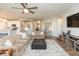 Open concept living room with abundant space, wood floors, modern lighting, and a cozy ambiance at 5694 Walkabout Way, Brownsburg, IN 46112
