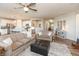 Bright, open-concept living space with wood floors connecting the kitchen and a cozy living area with contemporary decor at 5694 Walkabout Way, Brownsburg, IN 46112