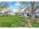 Expansive backyard featuring a patio, grilling station, mature trees, and lush lawn, ideal for outdoor living at 594 N Shore Blvd, Franklin, IN 46131