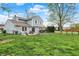 Spacious fenced backyard with a patio, fire pit, and well-manicured lawn offers ample space for outdoor activities at 594 N Shore Blvd, Franklin, IN 46131