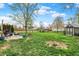 Well-maintained backyard featuring a patio, storage shed, mature tree, and a fire pit for outdoor enjoyment at 594 N Shore Blvd, Franklin, IN 46131