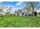 Large, grassy backyard with a patio, grilling area, and mature trees, creating a private outdoor retreat at 594 N Shore Blvd, Franklin, IN 46131