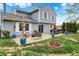 Spacious backyard featuring a patio with dining and seating areas, surrounded by green grass at 594 N Shore Blvd, Franklin, IN 46131