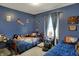 Bedroom with baseball decor featuring blue walls, comfortable beds, and natural light from the window at 594 N Shore Blvd, Franklin, IN 46131